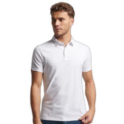 Koszulka polo z dżerseju Superdry Studios. Białe koszulki polo Superdry, m, bez wzorów, z dżerseju, bez kołnierzyka, bez ramiączek. W wyprzedaży za 176.45 zł.