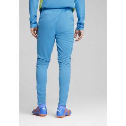 Męskie spodnie treningowe Manchester City PUMA Magic Blue Yellow Glow. Niebieskie spodnie treningowe długie Puma, m, bez wzorów, z dresówki. W wyprzedaży za 188.50 zł.