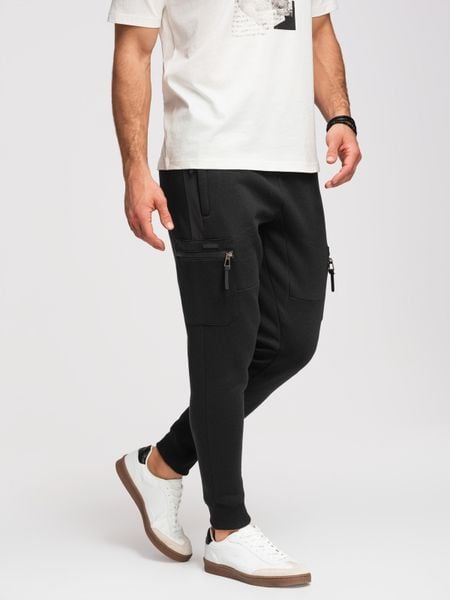 Spodnie dresowe męskie JOGGER z kieszeniami na udach i kontrastującymi wstawkami - czarne V1. Czarne joggery i bojówki Ombre Clothing, na co dzień, m, bez wzorów, z dresówki. Za 229.99 zł.