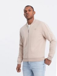 Lekka kurtka męska bomberka z logowaną podszewką - jasnobeżowa V2. Brązowe kurtki Ombre Clothing, l, z aplikacjami, z bawełny, bez kaptura. W wyprzedaży za 119.99 zł.