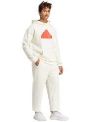 Adidas Spodnie dresowe "Future Icons Badge of Sport" w kolorze kremowym rozmiar: M. Brązowe spodnie treningowe długie Adidas, m, bez wzorów, z dresówki. Za 118.28 zł.
