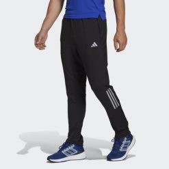 Spodnie Own the Run Astro Knit. Czarne buty do biegania Adidas, bez wzorów, bez zapięcia, do biegania. W wyprzedaży za 194.35 zł.