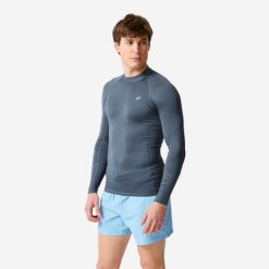 Top UV surfingowy męski Decathlon 100 długi rękaw. Niebieskie bluzki z długim rękawem Decathlon, m, bez wzorów, z elastanu, bez kołnierzyka, bez ramiączek. Za 59.99 zł.