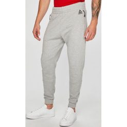 Reebok - Spodnie. Szare spodnie treningowe długie Reebok, l, bez wzorów, z bawełny. W wyprzedaży za 199.90 zł.