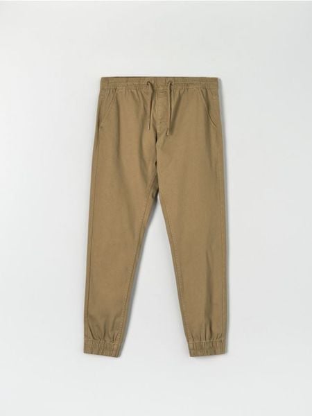Spodnie jogger - beżowy. Brązowe joggery i bojówki Sinsay, m, bez wzorów, z bawełny. Za 49.99 zł.