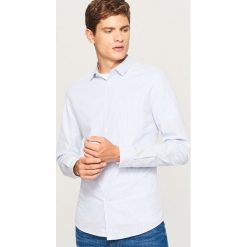 Koszula slim fit w paski - Niebieski. Koszule marki Under Armour. W wyprzedaży za 49.99 zł.
