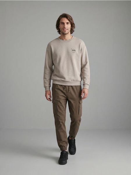 Spodnie cargo jogger - brązowy. Brązowe joggery i bojówki Sinsay, bez wzorów. Za 59.99 zł.