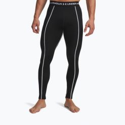 Legginsy Under Armour Cold Weather Grid. Czarne legginsy długie sportowe Under Armour, bez wzorów, na fitness i siłownię. Za 179.99 zł.