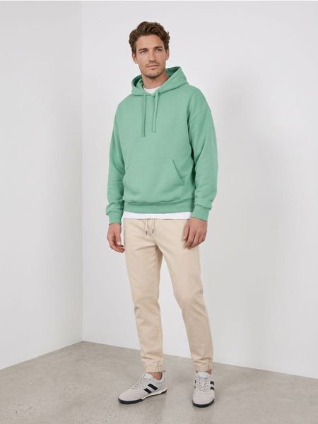 Bluza z kapturem comfort fit z domieszką bawełny - zielony. Zielone bluzy z kapturem Sinsay, l, bez wzorów, z bawełny, z kapturem. Za 39.99 zł.