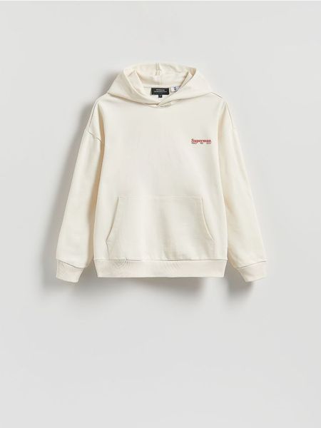 Bawełniana bluza z kapturem SUPERMAN™ - złamana biel. Bluzy z kapturem Reserved, l, bez wzorów, z bawełny, z kapturem. W wyprzedaży za 129.99 zł.