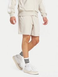 Adidas Szorty sportowe Essentials Linear JC9346 Beżowy Regular Fit. Brązowe krótkie spodenki sportowe Adidas, m, bez wzorów, z bawełny. Za 119.99 zł.