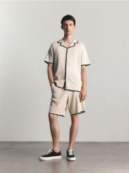Bawełniane szorty dresowe - złamana biel. Krótkie spodenki sportowe Reserved, l, bez wzorów, z bawełny. Za 129.99 zł.