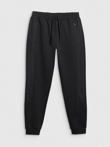 4F Spodnie dresowe w kolorze czarnym rozmiar: S. Czarne spodnie treningowe długie 4F, s, bez wzorów, z dresówki. Za 92.42 zł.