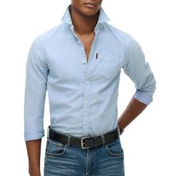 Wyblakana koszula Superdry Oxford. Niebieskie koszule Superdry, xl, bez wzorów, z bawełny, bez kołnierzyka, bez ramiączek. Za 295.45 zł.