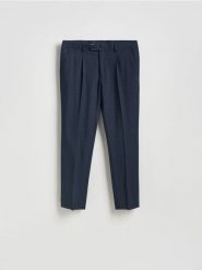 Spodnie garniturowe slim fit - granatowy. Niebieskie garnitury Reserved, bez wzorów, z elastanu. Za 169.99 zł.