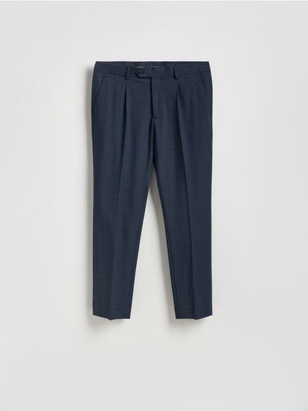 Spodnie garniturowe slim fit - granatowy. Niebieskie garnitury Reserved, bez wzorów, z elastanu. Za 169.99 zł.
