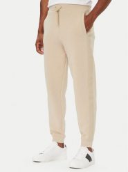 Guess Spodnie dresowe Z6YB13 K4965 Beżowy Regular Fit. Brązowe spodnie materiałowe Guess, m, z aplikacjami, z bawełny. Za 394.99 zł.