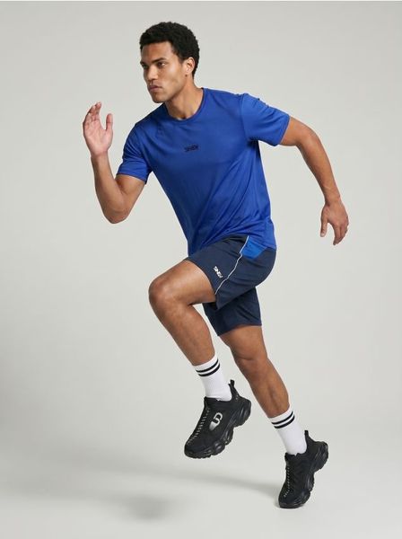 Szorty sportowe SNSY PERFORMANCE - granatowy. Niebieskie krótkie spodenki sportowe Sinsay, l, bez wzorów. Za 39.99 zł.
