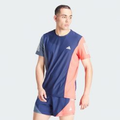 Koszulka Own The Run Colorblock. Czerwone buty do biegania Adidas, bez wzorów, z materiału, bez zapięcia, do biegania. W wyprzedaży za 156.75 zł.