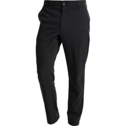 Under Armour TAKEOVER GOLF PANT TAPER Spodnie materiałowe black. Spodnie treningowe długie marki Under Armour. Za 359.00 zł.
