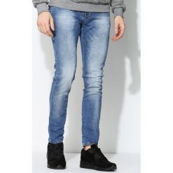 Niebieskie Jeansy Decline. Jeansy marki Under Armour. Za 64.99 zł.