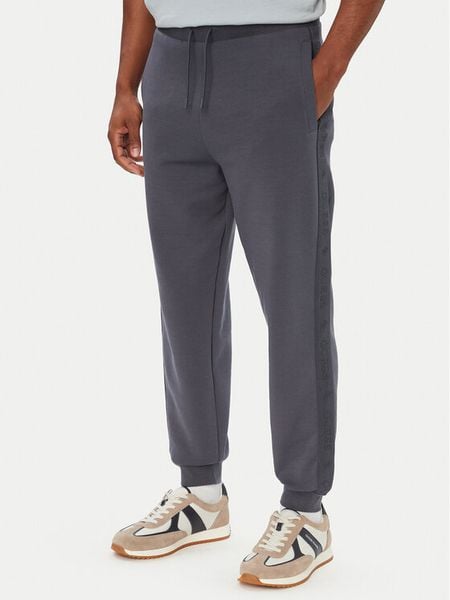 Guess Spodnie dresowe Z6YB13 K4965 Niebieski Regular Fit. Niebieskie spodnie materiałowe Guess, m, z aplikacjami, z bawełny. Za 394.99 zł.