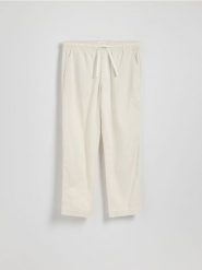 Bawełniane spodnie jogger - złamana biel. Joggery i bojówki Reserved, l, bez wzorów, z bawełny. Za 119.99 zł.