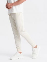 Bawełniane męskie dresowe spodnie joggery BASIC – kremowe V5 OM-PABS-0174 - XXL. Białe joggery i bojówki Ombre Clothing, l, bez wzorów, z bawełny, eleganckie. Za 119.99 zł.