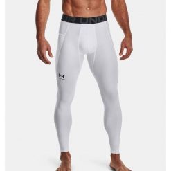 Legginsy Under Armour HeatGear. Białe legginsy długie sportowe Under Armour, bez wzorów, do biegania. Za 99.99 zł.