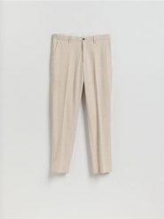 Garniturowe spodnie slim fit - beżowy. Brązowe garnitury Reserved, bez wzorów, z tkaniny. Za 169.99 zł.