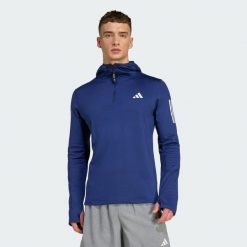 Bluza z kapturem Own The Run Winterized Hooded Half-Zip. Niebieskie bluzy Adidas, bez wzorów, bez zapięcia, do biegania, ClimaWarm (Adidas). Za 279.00 zł.