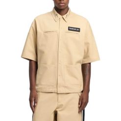 Kurtka REEBOK S S SHIRT Jasnobrązowy. Brązowe kurtki Reebok, m, bez wzorów, z tkaniny, bez kaptura. Za 329.99 zł.