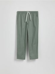 Bawełniane spodnie jogger - jasnozielony. Zielone joggery i bojówki Reserved, l, bez wzorów, z bawełny. Za 119.99 zł.
