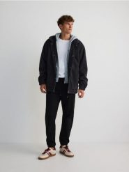Spodnie jogger slim - czarny. Czarne joggery i bojówki Reserved, l, bez wzorów, z bawełny. Za 129.99 zł.