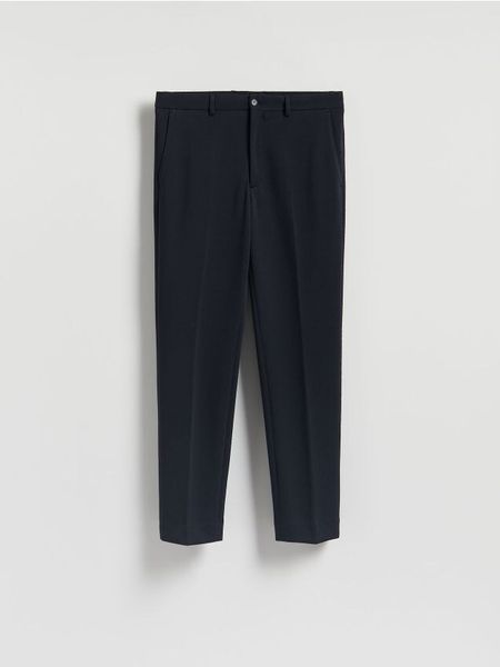 Spodnie garniturowe slim fit - granatowy. Niebieskie garnitury Reserved, l, bez wzorów, z bawełny. W wyprzedaży za 99.99 zł.