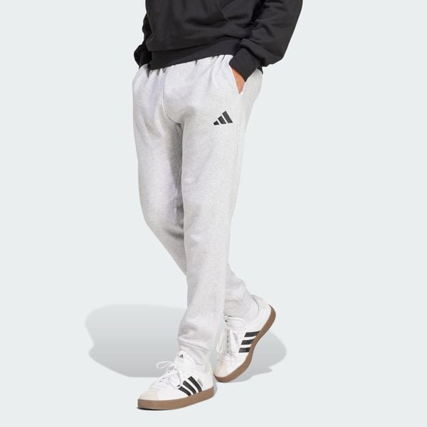 Spodnie polarowe Essentials Feelcozy. Czarne eleganckie spodnie Adidas, bez wzorów, z polaru. Za 219.00 zł.