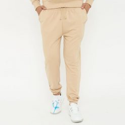 Spodnie sportowe unisex F BALLON beżowe. Brązowe spodnie treningowe długie Legea, bez wzorów, z gumy. W wyprzedaży za 92.00 zł.