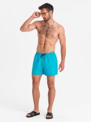 Neonowe szorty męskie kąpielowe z efektem magic print – turkusowe V2 - Rozmiar: S. Niebieskie kąpielówki Ombre Clothing, m, bez wzorów, z poliesteru, krótkie. W wyprzedaży za 79.99 zł.