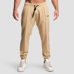 Spodnie męskie fitness jogger beżowe ARC. Brązowe joggery i bojówki GYMBEAM, m, bez wzorów, z elastanu, sportowe. Za 127.90 zł.