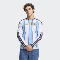 Argentina 26 Home Replica Koszulka z długim rękawem. Białe bluzki z długim rękawem Adidas, bez wzorów, bez kołnierzyka, bez ramiączek. Za 479.00 zł.