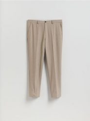 Garniturowe spodnie carrot - beżowy. Brązowe garnitury Reserved, bez wzorów, z tkaniny. Za 169.99 zł.