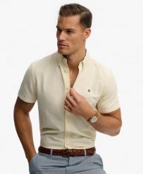Superdry Koszula Preppy Oxford krótki rękaw Pastel Yellow Chambray. Żółte koszule Superdry, uniwersalny, bez wzorów, z bawełny, bez kołnierzyka, bez ramiączek. Za 301.95 zł.
