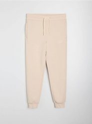 Spodnie jogger slim fit - beżowy. Brązowe joggery i bojówki Sinsay, l, bez wzorów, sportowe. Za 49.99 zł.