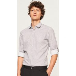 Koszula z mikroprintem regular fit - Pomarańczo. Koszule marki Under Armour. Za 89.99 zł.