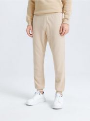 Spodnie dresowe jogger - beżowy. Brązowe joggery i bojówki Sinsay, l, bez wzorów, z bawełny. Za 29.99 zł.