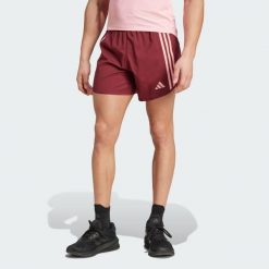 Szorty Own the Run 3-Stripes. Czerwone szorty Adidas, bez wzorów, z materiału, sportowe. Za 229.00 zł.