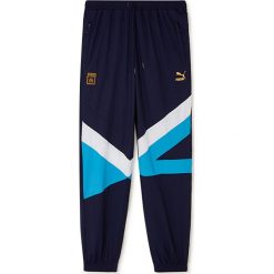 Spodnie "Olympique Marseille" w kolorze granatowym. Niebieskie spodnie treningowe długie marki Puma, bez wzorów, z materiału. W wyprzedaży za 108.95 zł.