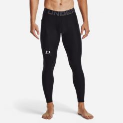 Legginsy męskie Under Armour HeatGear®. Czarne legginsy długie sportowe Under Armour, l, bez wzorów, z materiału, na fitness i siłownię. Za 129.99 zł.
