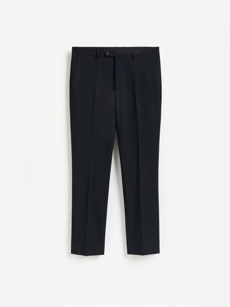 Spodnie garniturowe slim fit - granatowy. Niebieskie garnitury Reserved, l, bez wzorów, z tkaniny. Za 169.99 zł.