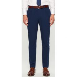 Spodnie garniturowe slim fit - Granatowy. Garnitury marki Under Armour. Za 129.99 zł.